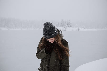 woman standing in the middle of snow covered land thumbnail
