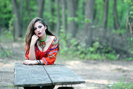 woman in reed dress leaning on table thumbnail