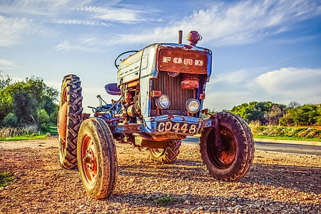 blue tractor on field thumbnail