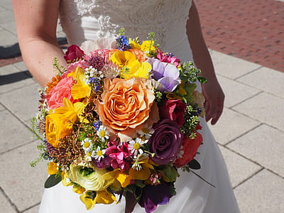 woman holding bouquet of assorted-color flowers thumbnail