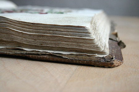 macro shot of brown and white book on top of table thumbnail