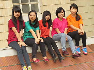 five women sitting on roof smiling thumbnail