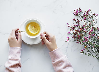 person in pink sweatshirt holding white cup thumbnail