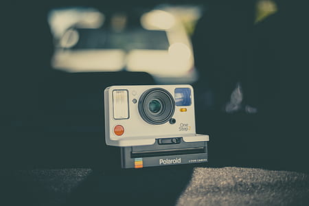 white and black Polaroid land camera on black textile thumbnail