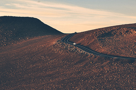 desert with black asphalt road during daytime thumbnail