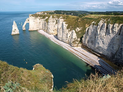 gray canyon near body of water during daytime thumbnail