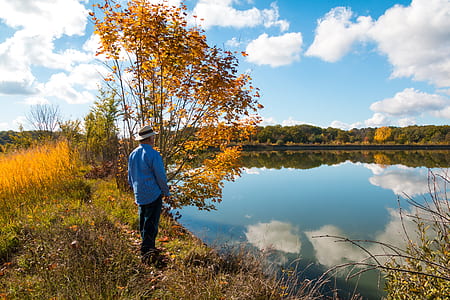 man standing in front of body of water thumbnail