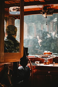 Man Wearing Black Jacket Driving Brown Bus thumbnail