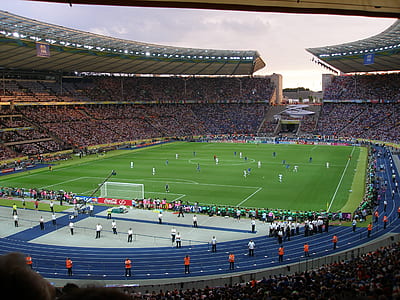 portrait photography of soccer stadium during daytime thumbnail