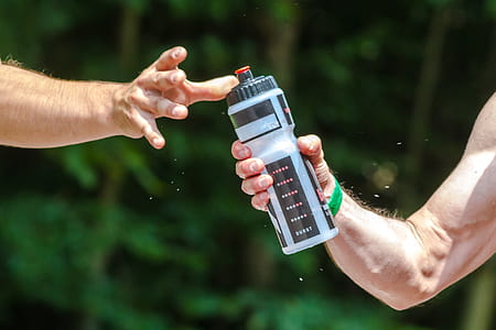 person passing the bottle the another person thumbnail