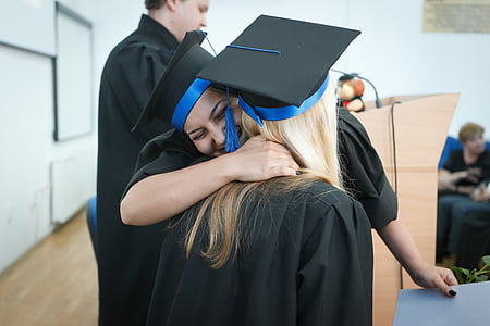 two women hugs during graduation thumbnail