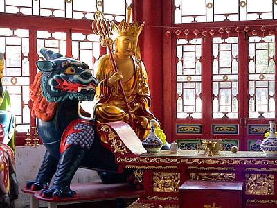 Buddha statue near rectangular red table at daytime thumbnail
