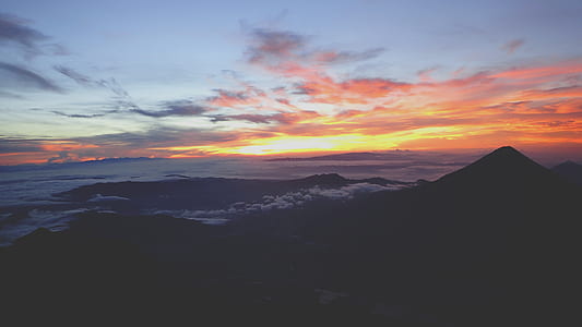 silhouette of mountain under sky panoramic photography thumbnail