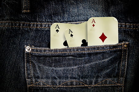 closeup photo of three gaming card on pocket thumbnail