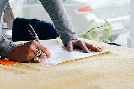man writing on white paper thumbnail