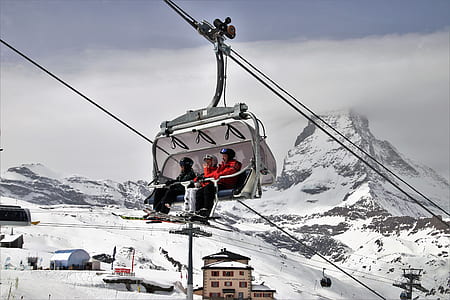 three person riding cable car during daytime thumbnail