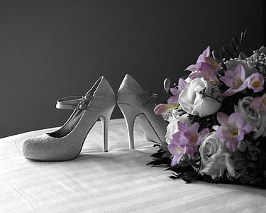 pair of women's gray stilettos beside pink and white flower bouquet thumbnail