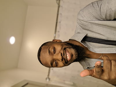 man wearing gray shirt with pointing his right index finger towards the direction of the camera thumbnail