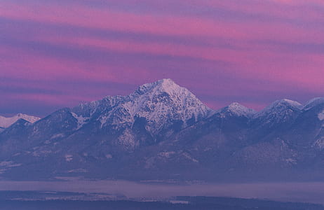 snow-capped mountain under pink crimson sky thumbnail