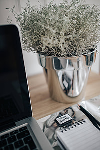 MacBook Pro with headphones on a wooden desk thumbnail
