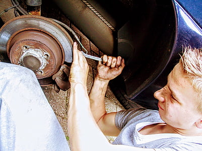 man repairing vehicle during daytime thumbnail