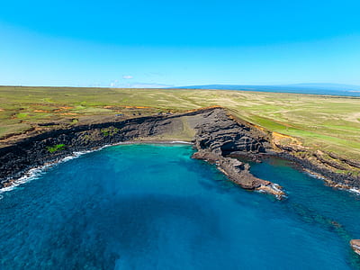 body of water near green land thumbnail
