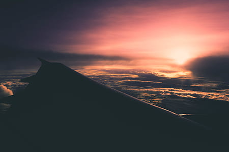 depth photography of airplane wing during sunset thumbnail