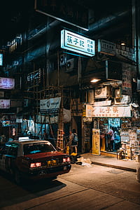 taxi on street near stores and buildings thumbnail