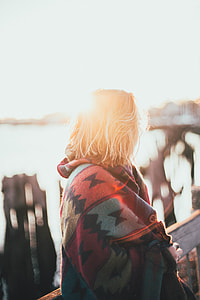 blonde haired woman with red, blue, and black jacket in tilt shift photography thumbnail