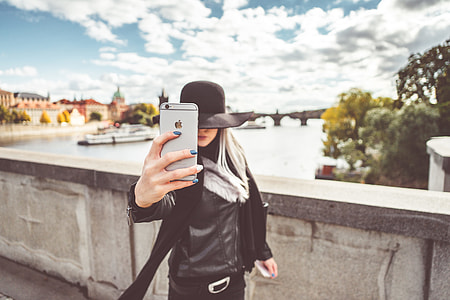 Young Woman Taking a Selfie with Her iPhone thumbnail
