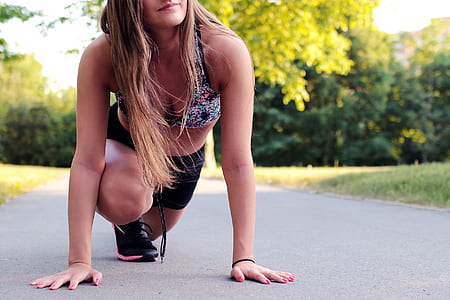 Women's Wearing Purple Floral Brassiere Holding Gray Concrete Pathway during Day Time thumbnail