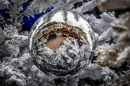 houses and trucks reflected in silver-colored bauble decor thumbnail