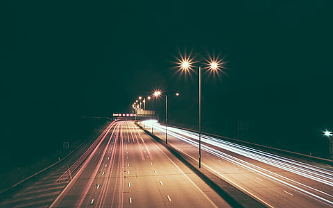 time-lapse photography of open road during nighttime thumbnail