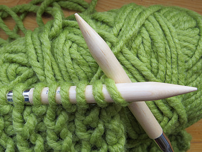 knitting needles with green yarn thumbnail