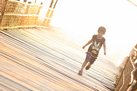 boy in black tank top running thumbnail