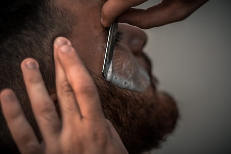 Person Holding Gray Straight Razor thumbnail