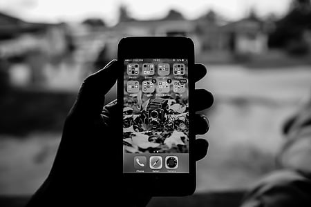 grayscale photo of turned on iPhone thumbnail