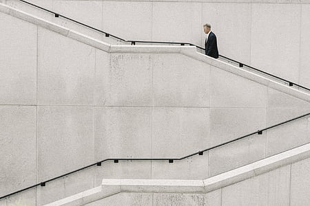 man walking on gray concrete stairs thumbnail