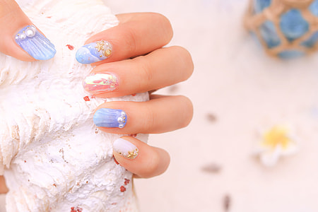 person holding white shell thumbnail