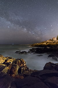 rock mountain with fogs under starry sky thumbnail