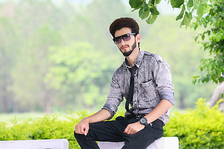 man sitting near plant thumbnail
