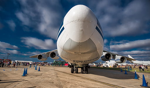 white plane on gray pavement during daytime thumbnail