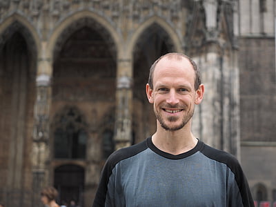 man wearing gray and black crew-neck shirt while smiling thumbnail