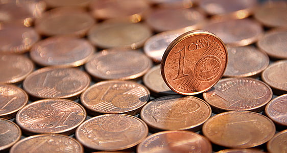 1 cent coin balancing on coins thumbnail