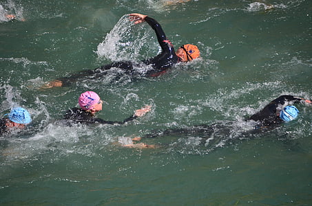 group of people swimming on body of water thumbnail
