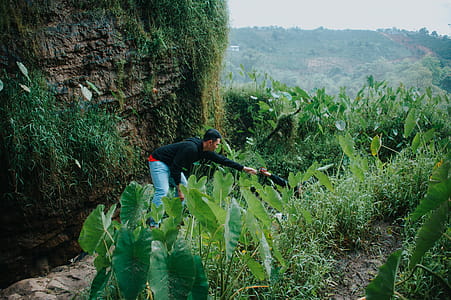 Man Wearing Black Long-sleeved Shirt and Blue Denim Bottoms thumbnail