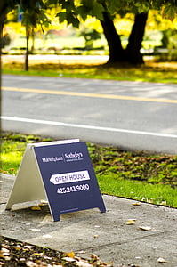 blue signage beside black asphalt road thumbnail