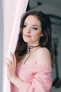 woman holding curtain thumbnail