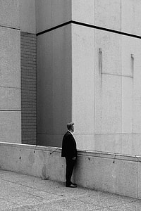 man standing near concrete wall thumbnail