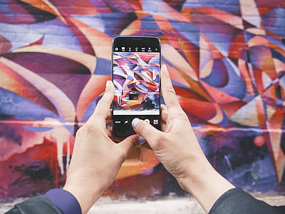 person holding Android smartphone taking photo thumbnail